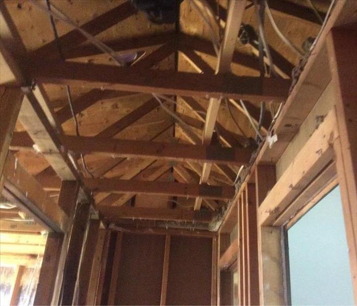 Room with new studs and roofing exposed beams