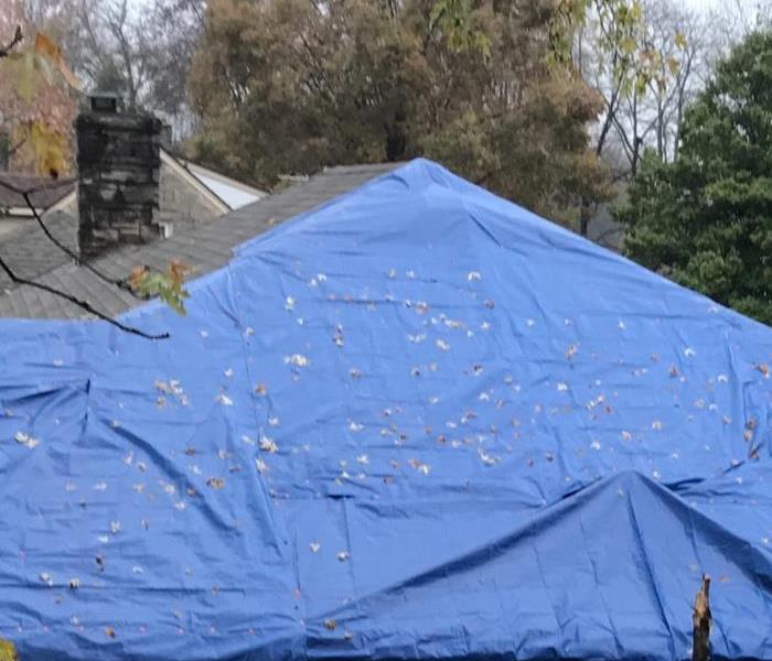 Roof tarped with a blue tarp