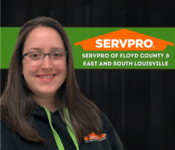 Woman wearing a SERVPRO shirt standing in front of black background